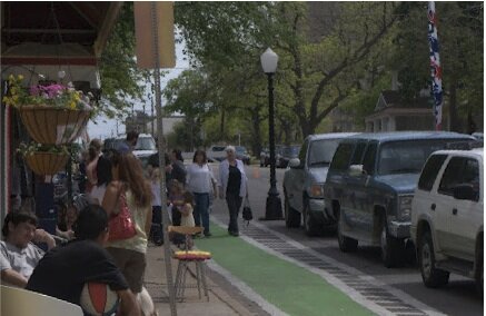 A temporary buffered bike lane next to pop up retail at the first Better Block demonstration in Dallas, TX. Source: Jason Roberts, Better Block